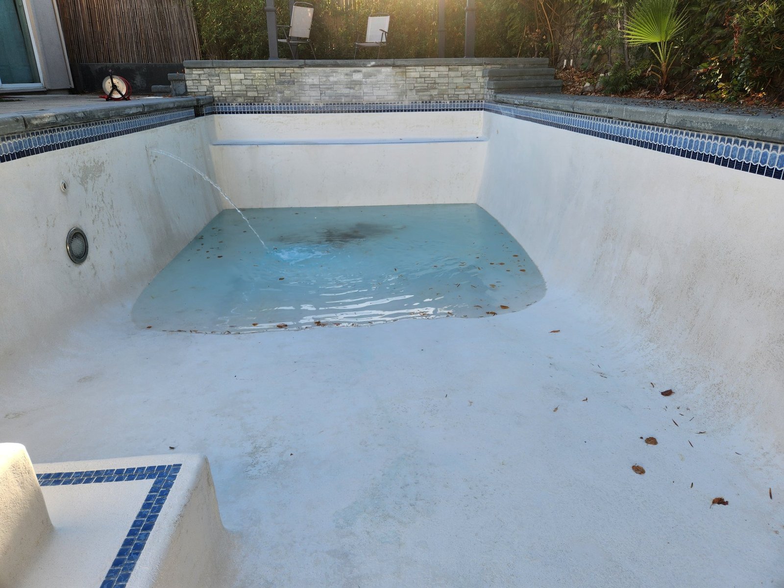 Clean white deep end refilling after an acid wash in Roseville, CA